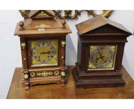 A VICTORIAN WALNUT AND GILT BRASS MOUNTED STRIKING BRACKET CLOCK TOGETHER WITH A FURTHER VICTORIAN OAK CASED EXAMPLE