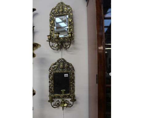 A PAIR OF CAST BRASS THREE LIGHT WALL SCONCES WITH MIRROR BACKS