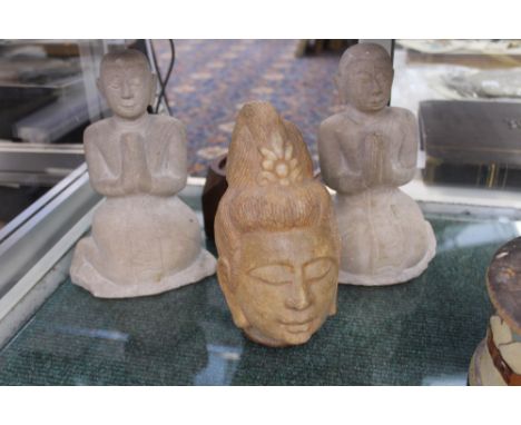 A PAIR OF CARVED MARBLE ORIENTAL FIGURES OF KNEELING DEITIES AND A CARVED STONE HEAD.