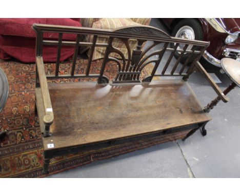 AN ARTS AND CRAFTS OAK HALL BENCH.