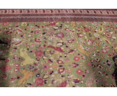 AN ANTIQUE PERSIAN CARPET OF HUNTING DESIGN
POOR CONDITION- ALMOST NO PILE TO 80% OF THE FACE
ILLUSTRATIONS SHOW THE UNDERSID