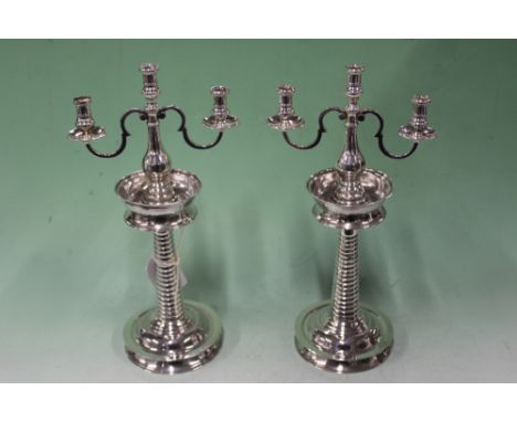 A PAIR OF WHITE METAL CANDLESTICKS WITH HALLMARKED SILVER THREE LIGHT BRANCHES