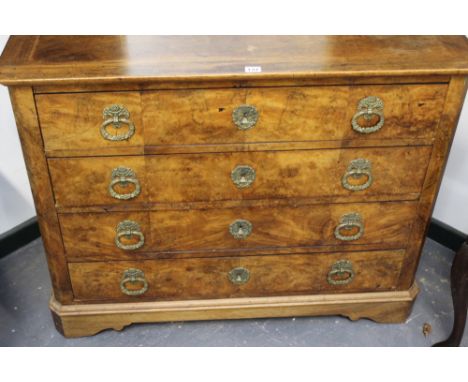 A CONTINENTAL WALNUT FOUR DRAWER CHEST ON SHAPED BRACKET FEET