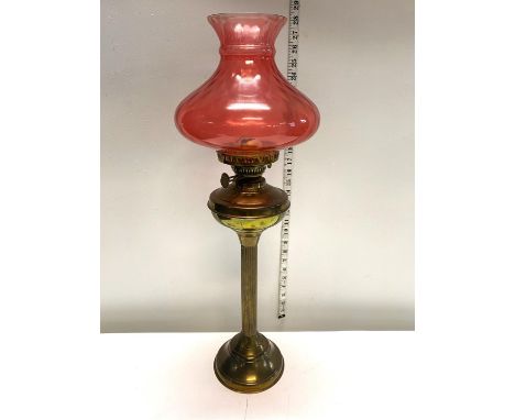 A antique oil lamp with brass column and Cranberry shade h67cm, shipping unavailable 