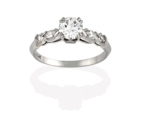 A Diamond Solitaire Ring, the round brilliant cut diamond in a white claw setting, to a marquise and round brilliant cut diam