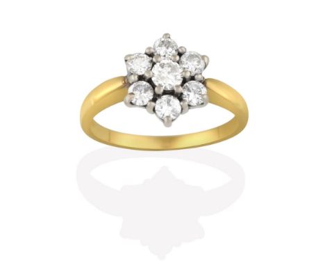 An 18 Carat Gold Diamond Cluster Ring, seven round brilliant cut diamonds, in white claw settings, to a yellow tapered should