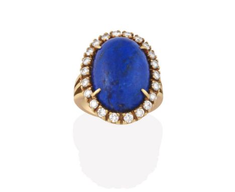 A Lapis Lazuli and Diamond Cluster Ring, the oval lapis lazuli cabochon within a border of round brilliant cut diamonds, in y