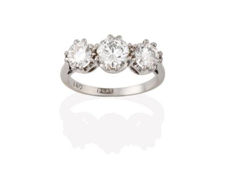 A Diamond Three Stone Ring, the graduated round brilliant cut diamonds in white claw settings, to a tapered shoulder plain po