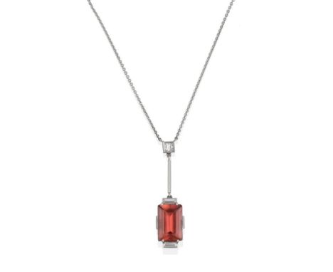 A Tourmaline and Diamond Necklace, the step cut pinky-brown tourmaline in a white claw setting, flanked by two baguette cut d