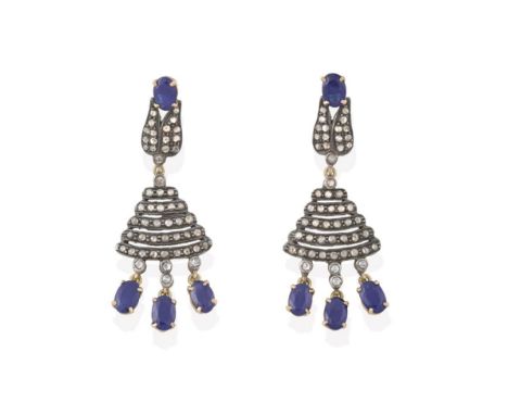 A Pair of Sapphire and Diamond Drop Earrings, five graduated rows of rose cut diamonds suspend three oval cut sapphires, surm