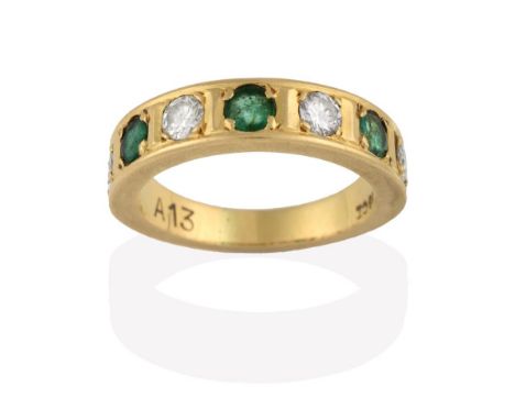 An Emerald and Diamond Half Hoop Ring, four round brilliant cut diamonds alternate with three round cut emeralds in yellow cl