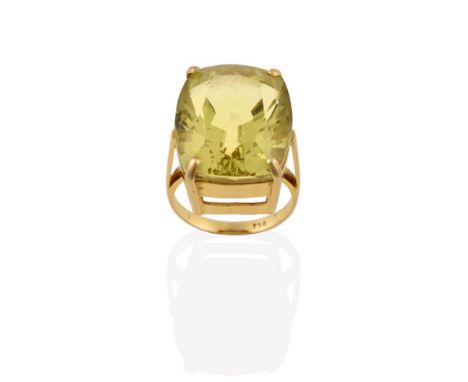 A Citrine Ring, the fancy oval cut citrine in a yellow four claw setting, to a tapered shoulder plain polished shank, finger 