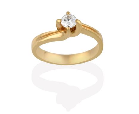 A Diamond Solitaire Ring, the round brilliant cut diamond in a yellow four claw setting, to an asymmetrical shoulder plain po