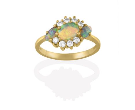 An 18 Carat Gold Opal and Diamond Cluster Ring, the three oval cabochon opals within a border of round brilliant cut diamonds