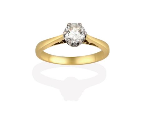 A Diamond Solitaire Ring, the round brilliant cut diamond in a white claw setting, to a tapered shoulder plain polished shank