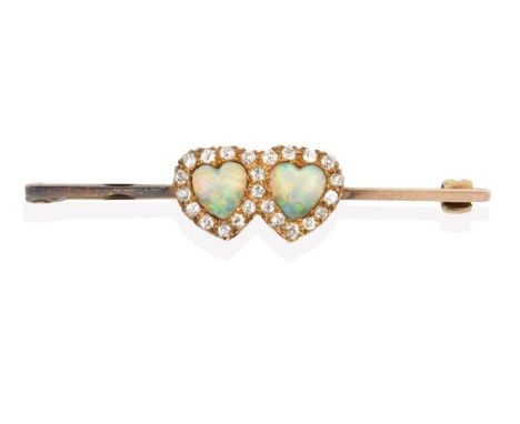 An Edwardian Opal and Diamond Brooch, two heart shaped cabochon opals within a border of old cut diamonds, in yellow claw set