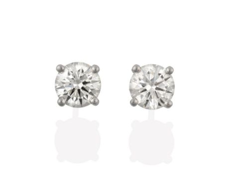 A Pair of 18 Carat White Gold Diamond Solitaire Earrings, the round brilliant cut diamonds in four claw settings, total estim