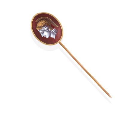 A Continental Enamel Stickpin, circa 1900, the oval concave plaque enamelled in red depicting a classical Greek head in profi