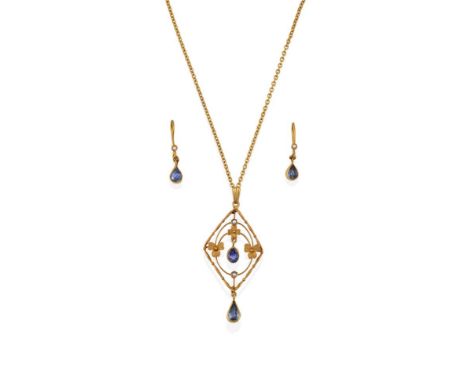 An Edwardian Sapphire and Seed Pearl Pendant on Chain, of openwork foliate lozenge design, with an oval cut sapphire centrall