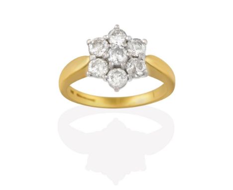 An 18 Carat Gold Diamond Cluster Ring, seven round brilliant cut diamonds, in white claw settings, to a yellow tapered should