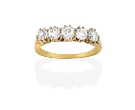 A Diamond Five Stone Ring, the old cut diamonds in yellow claw settings, to a tapered shoulder plain polished shank, total es