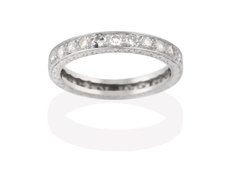 A Diamond Eternity Ring, the twenty-six round brilliant cut diamonds in white claw and channel settings, total estimated diam