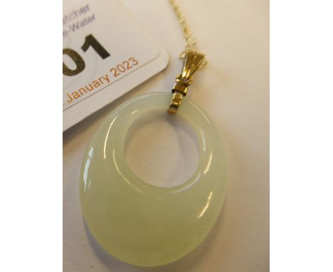 A jade pendant on a 9-carat gold chain