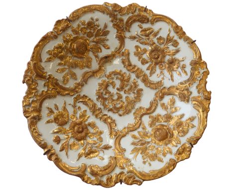 A 19th century Meissen bowl; hand-gilded in high relief with floral designs, blue crossed swords mark to underside (scored th