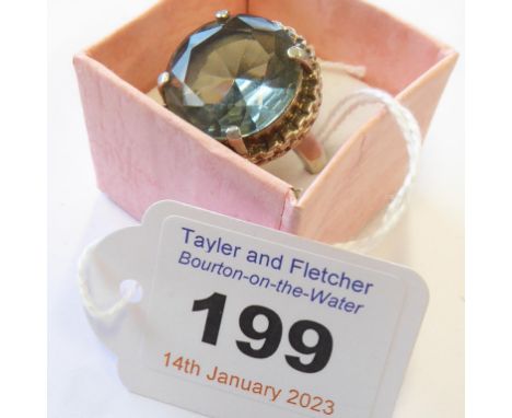 A lady's Fiorelli silver ring set with a large, single, hand-cut light blue/purple stone (boxed)