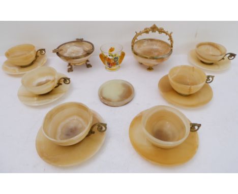 A set of six mid-20th century gilt-metal-mounted onyx cups and saucers, three other pieces of onyx and a small painted drinki