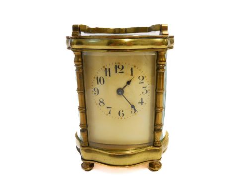 An early 20th century French brass and glass-sided carriage clock: ivory coloured dial with Arabic numerals, together with ke