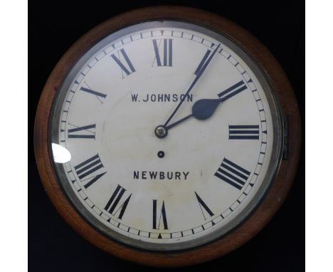 A late 19th / early 20th century oak-cased wall-hanging stationmaster-style clock: cream dial with Roman numerals and signed 