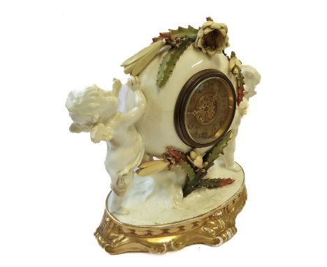 A late 19th century porcelain-cased mantle clock timepiece: the chapter ring (faded and oxidisation) with Roman numerals and 