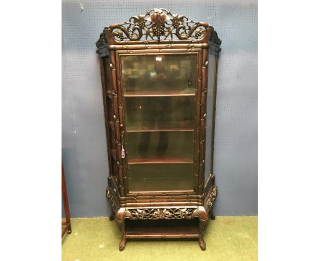 3 Shelf glazed hardwood Chinese cabinet decorated with elaborate carving on a hard wood stand 98 w 176 h cm 