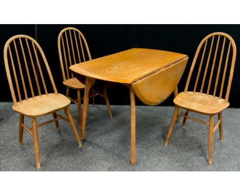 An Ercol elm drop-leaf dining table, 74.5cm high x 112.5cm x 68cm (130cm with leaves extended);  three Ercol oak stick back d