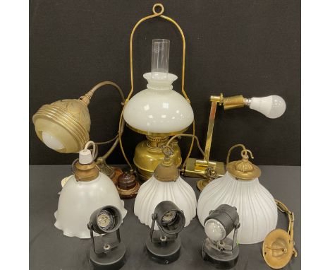 An Art Deco glass and brass scrolling arm wall light;  oil lamp,  near pair of graduated frosted glass pendant light fittings
