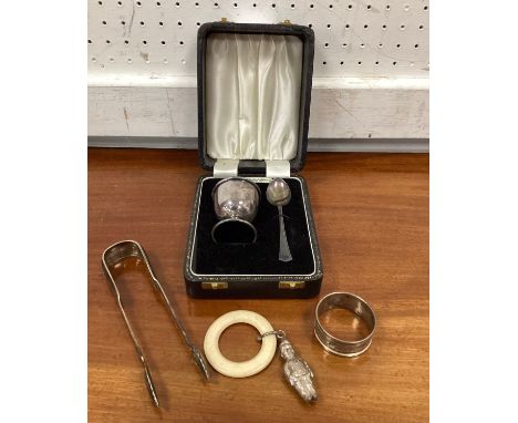 A silver two piece christening set cased;  pair of Scottish silver sugar tongs, Edinburgh 1893;  napkin ring, baby teathing r