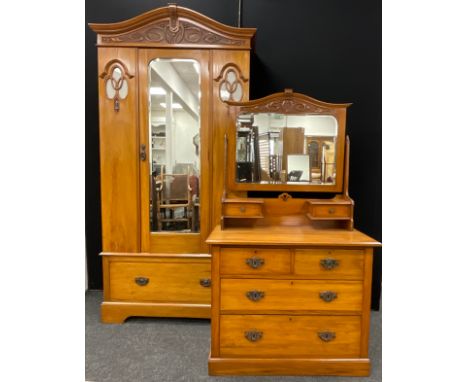 An Edwardian art nouveau walnut wardrobe and matching dressing chest, the wardrobe measuring 211.5cm high x 102cm wide, (2). 