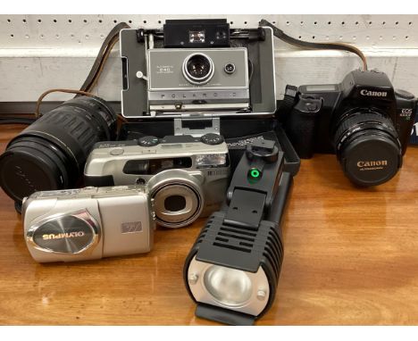 Cameras and camera equipment - Polaroid Automatic 240 Land Camera;  Sunpak CV-300 compact video light;  Canon EOS 1000F, SLR 