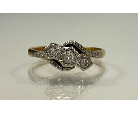 A diamond twist ring, set with three graduated old round brilliant cut diamonds, total estimated diamond weight approx 0.18ct