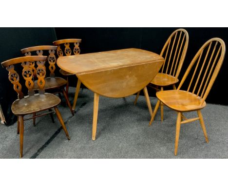 An Ercol elm drop-leaf dining table, oval top, 71.5cm high x 113cm x 124cm wide when extended;  a pair of Ercol stick back di
