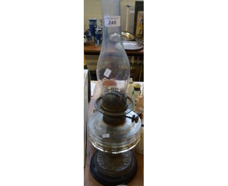A 20th Century brass oil lamp with faceted reservior.