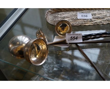 A white metal toddy ladle with black ebonised turned handle.