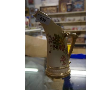 A Royal Worcester blush ivory ewer with hand painted floral decoration and gilt rim and base with horn style handle