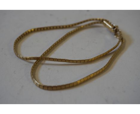 A 14ct yellow gold double string bracelet, featuring nicely engineered engine turned square links, approx 10.5gms. 