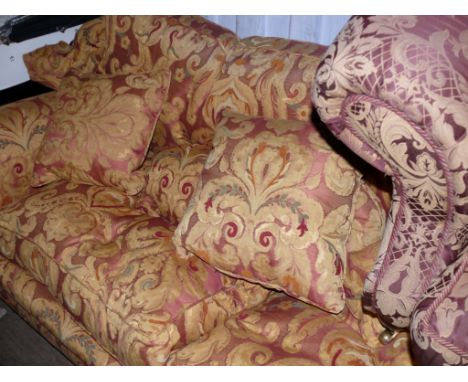 A large three seater sofa in mustard and red floral design.