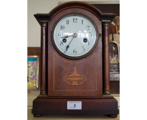 An Edwardian inlaid mahogany bracket clock raised on four ball feet