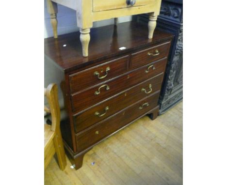 A Georgian style mahogany straight front chest of drawers, raised on bracket feet 
