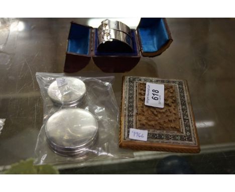 A mixed group of items to include a pair of napkin rings modelled as belts, two hallmarked silver trinket boxes and an anglo 
