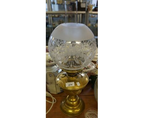 A 20th century brass oil lamp with frosted glass shade
